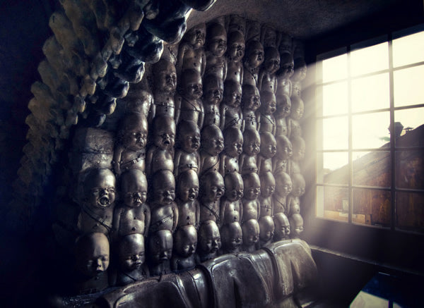 Wall with sculptures of stacked babies